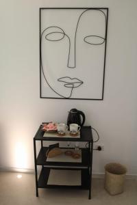 a black cart with a picture of a face on the wall at Suite Alborelli in Alberobello