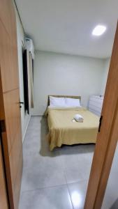 a bedroom with a bed with a phone on it at Apartamento aconchegante completo -Próximo ao Aeroporto-COP30 in Belém