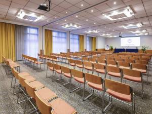 a lecture hall with chairs and a podium in it at Novotel Venezia Mestre Castellana in Mestre +137 photos