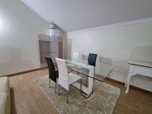 a dining room with a glass table and chairs at Dª Xica Holidays in Santa Cruz