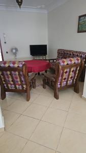 two wooden benches with a red cloth on them at Great flat near shops, food and beach in M'diq