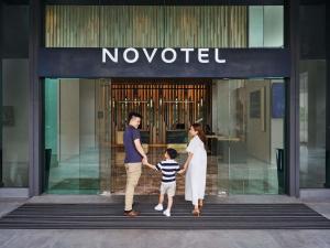 a family walking out of a no waited store at Novotel Bangkok Future Park Rangsit in Pathum Thani