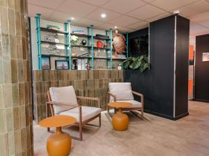 a room with two chairs and two tables and shelves at ibis budget Marseille Vieux Port in Marseille