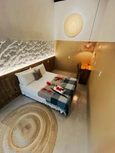 a bedroom with a bed and a large rug at Pousada Nascente do Sol in Ilha de Boipeba +154 photos