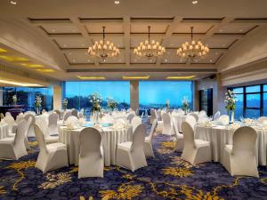 a conference room with tables and chairs and chandeliers at Sofitel Hangzhou Westlake - Few steps to West Lake, with panoramic lake view terrace in Hangzhou +96 photos