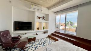 a bedroom with a bed and a tv and a window at Casa Lazuli 303 Cartagena in Cartagena de Indias