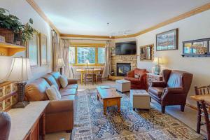 una sala de estar con un sofá y una mesa en Snow Flower 207, en Steamboat Springs
