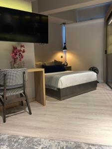 a bedroom with a bed and a tv on the wall at Apartamento in Bogotá