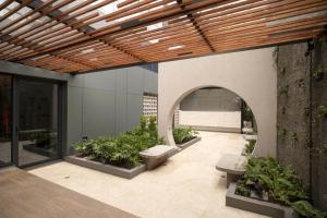 a courtyard with benches and plants in a building at Apartamento in Bogotá