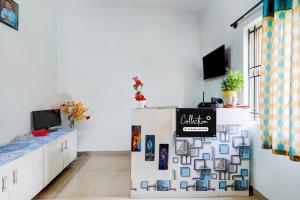 a room with a white wall with a sign on it at Super Collection O Uttarahalli in Bangalore