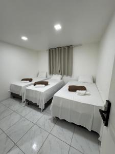 Una cama o camas en una habitación de Rede de Hotel 99 15 fotos más
