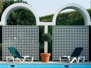 two chairs sitting next to a swimming pool at Ibis Styles Cognac in Châteaubernard
