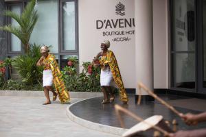 two women are standing in front of a building at D'avenue Boutique Hotel Accra in Accra
