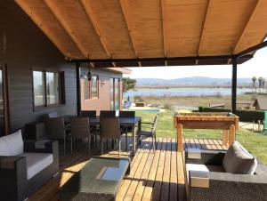 a patio with a table and chairs and a view of a lake at Casa vista Lago Rapel in Las Cabras