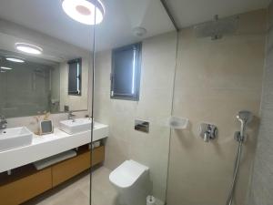 a bathroom with a toilet and a sink and a shower at Eden Deluxe, Jacuzzi & Sea in Mijas Costa +14 photos