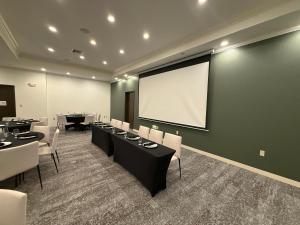 a conference room with tables and a projection screen at Wyndham Lake Charles in Lake Charles +24 photos
