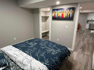 a bedroom with a bed and a flat screen tv at Peaceful 1BHK - Maple in Edmonton