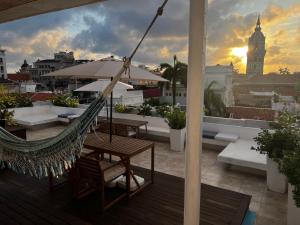 a hammock on a rooftop with a view of a city at Casa Lazuli 303 Cartagena in Cartagena de Indias