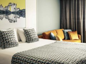 a hotel room with a bed and a couch at Mercure Swansea Hotel in Swansea +64 photos