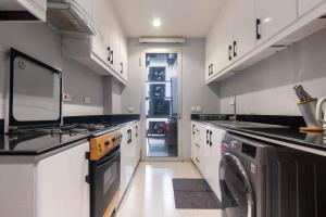a large kitchen with a washer and dryer in it at EasyStay Apartments in Ogere +10 photos