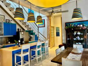 a kitchen with blue and yellow cabinets and a table and chairs at Casa Lazuli 303 Cartagena in Cartagena de Indias +23 photos