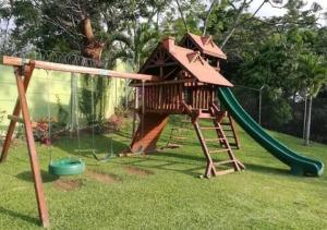 a playground with a tree house and a slide at Near Airport - Lush Gardens, Pool, King Bed, Security in Santa Ana