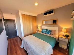 a small bedroom with a bed and two lamps at Near Airport - Lush Gardens, Pool, King Bed, Security in Santa Ana +13 photos