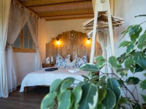 a bedroom with a bed with blue and white pillows at Apartmán Schwaderbach in Bublava