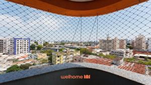 a view of a city from a wire fence at Apartamento em Londrina no Centro da cidade in Londrina