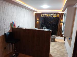 a bar in a room with a sign on the wall at Elit Hotel in Mingachevir