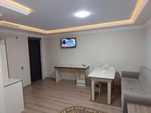 a living room with a couch and a table at Elit Hotel in Mingachevir
