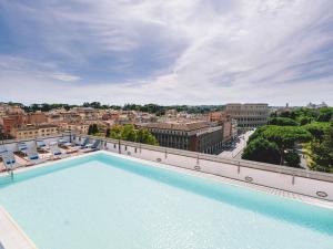 a large swimming pool on top of a building at Mercure Roma Centro Colosseo in Rome