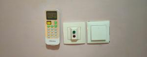 a remote control is attached to a wall at Rockville Building Studio Meuble Guest House in Yaoundé