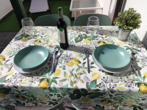 a table with a table cloth with a bottle of wine at Villa JALD in Abades