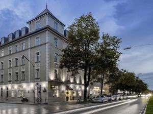 a large building on the side of a street at Mercure München am Olympiapark in Munich