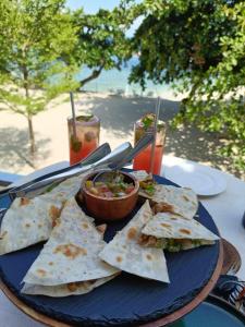 a blue plate with a plate of food on a table at El Paseo Tambuli in Maribago