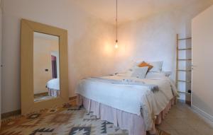 a bedroom with a large bed and a mirror at Gorgeous Home In Caccamo With Private Swimming Pool, Can Be Inside Or Outside in Caccamo