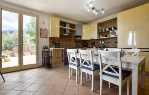 a kitchen with a table and chairs and a large window at Gorgeous Home In Caccamo With Private Swimming Pool, Can Be Inside Or Outside in Caccamo