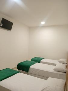 Postel nebo postele na pokoji v ubytování Gran Carlo Hotel