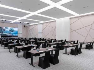 a conference room with tables and chairs and a screen at ibis Styles Sepang KLIA in Sepang +37 photos