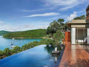 a house with a swimming pool with a view of a lake at V Villas Phuket - MGallery Collection in Panwa Beach