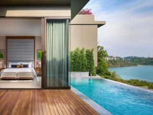 a bedroom with a bed and a swimming pool at V Villas Phuket - MGallery Collection in Panwa Beach +95 photos
