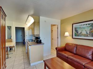 a living room with a couch and a kitchen at Harbour Beach Resort 503 in Daytona Beach