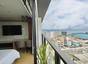 a bedroom with a balcony with a view of the ocean at Ejército City Lofts & Apartments by Geko in Lima
