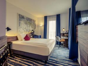 a hotel room with a bed and a desk at Mercure Hotel Hamburg Mitte in Hamburg +118 photos
