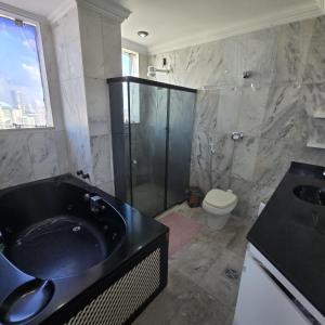 a bathroom with a black sink and a shower at COP 30 Apartamento Cobertura Duplex in Belém