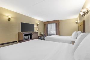 a hotel room with two beds and a flat screen tv at Best Western Plus Dryden Hotel and Conference Centre in Dryden +48 photos