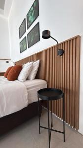 a bedroom with a bed and a table and a lamp at Residence X in Sao Paulo