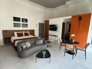 a living room with a bed and a couch and tables at Residence X in Sao Paulo +10 photos