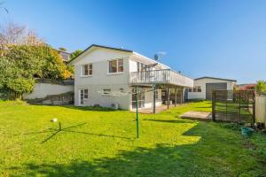 a house with a basketball hoop in the yard at 5 Bedrooms Lake View Cosy Place in Rotorua